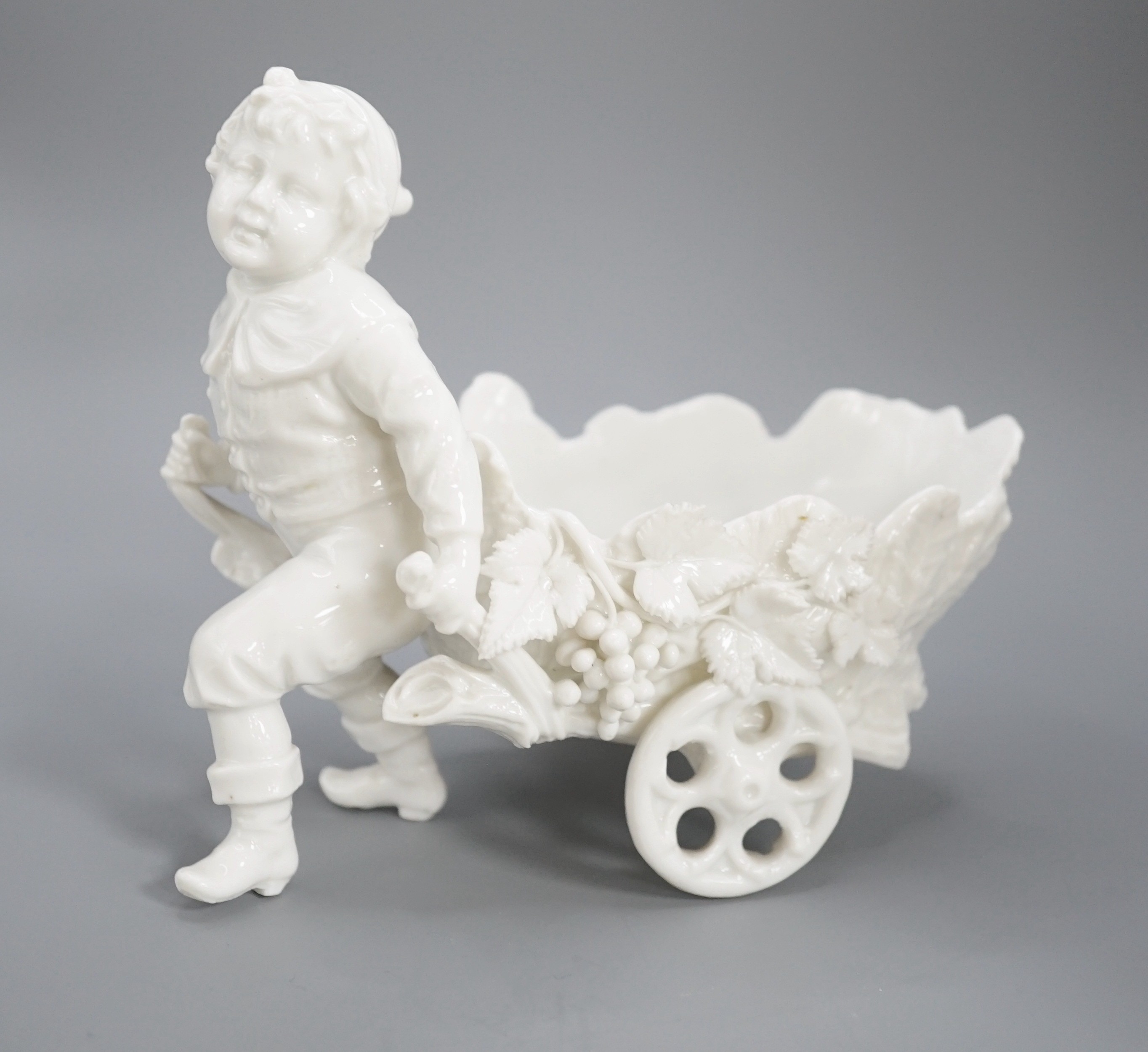 A pair of Continental porcelain cherub candlesticks, 13.5cm, a figural bonbon and a Derby figure